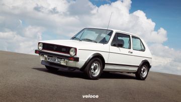 Non potevamo esimerci dal partire con la capostipite. Nel giugno del 1976, due anni dopo il debutto della prima Golf, arriva la GTI: forte del suo peso ridotto (810 kg) e del suo motore 1.6 ad iniezione elettronica da 110 cavalli, la prima hothatch della storia raggiungeva di slancio i 180 km/h. Fu subito un instant classic