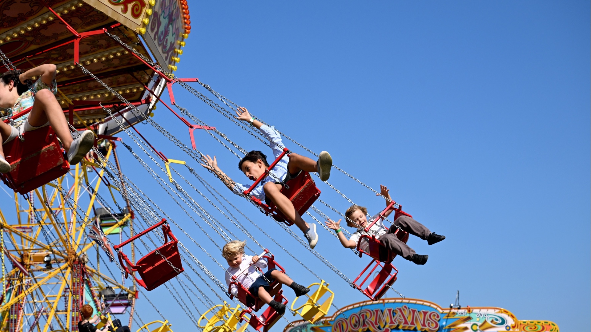 Visitors enjoying the fun fair at the 2023 Goodwood Revival. Ph. by PA.